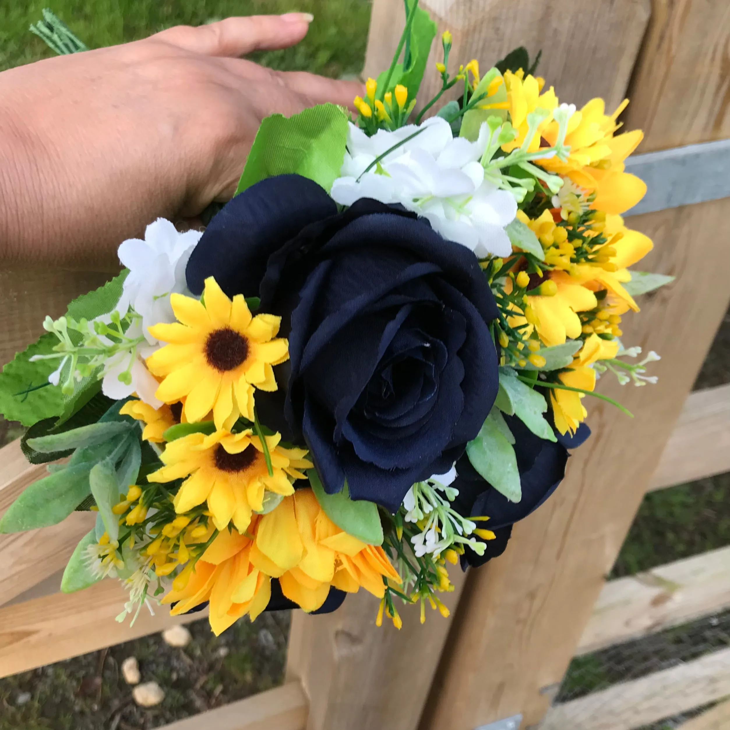 A collection of wedding bouquets featuring  sunflowers and either royal or navy blue roses