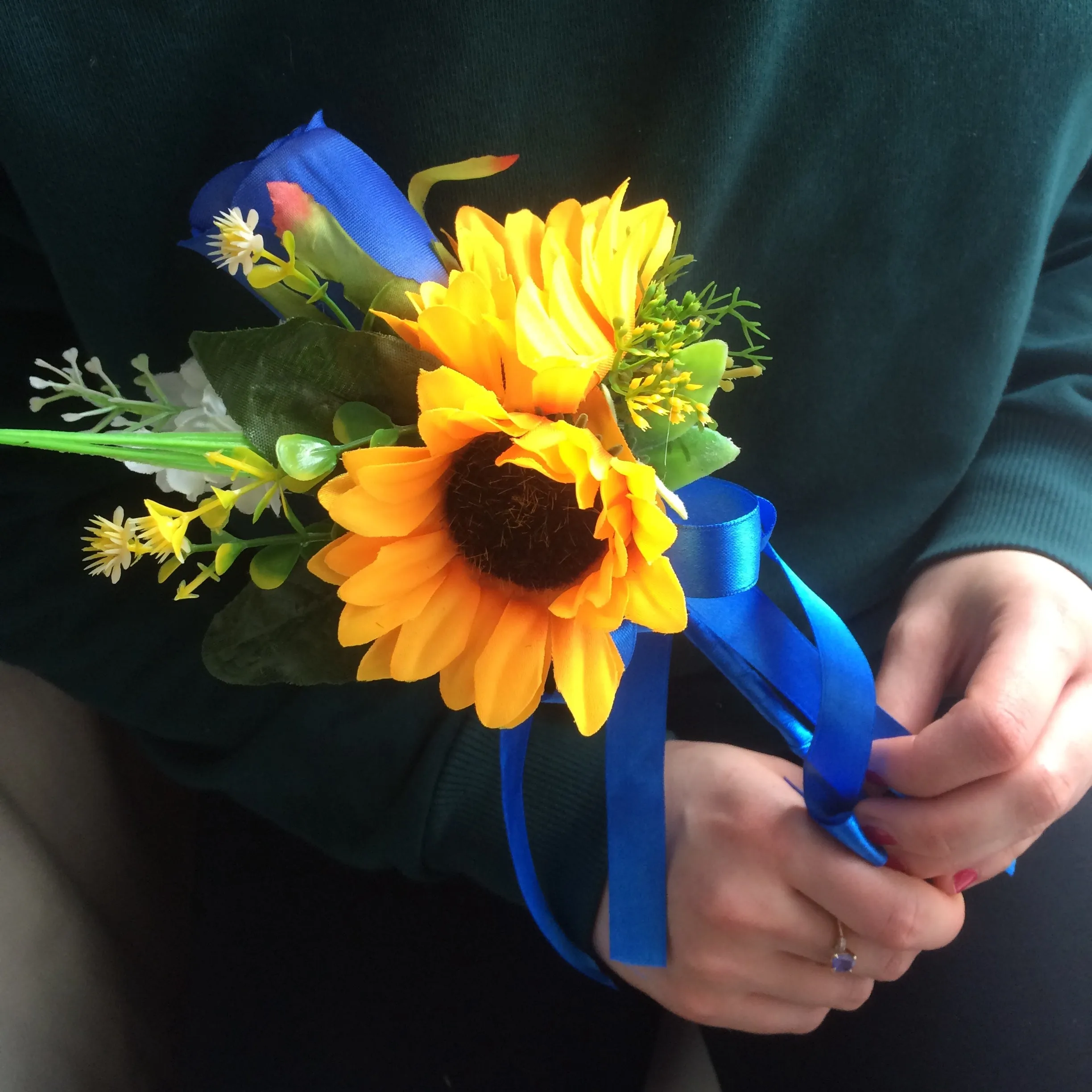 A collection of wedding bouquets featuring  sunflowers and either royal or navy blue roses